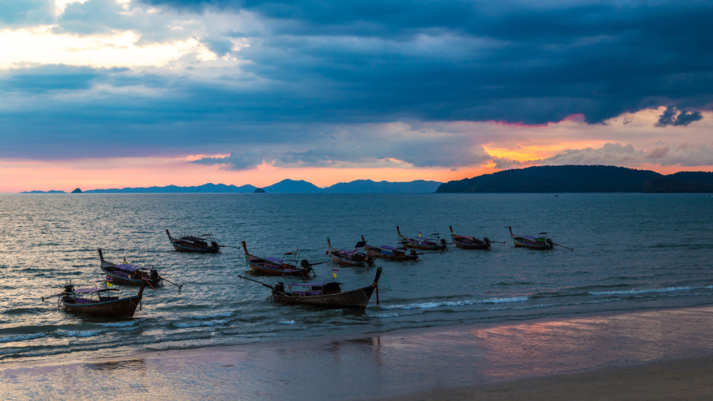 Longtail boats in the Andaman Sea at sunset, Ao Nang Beach, Krabi Thailand