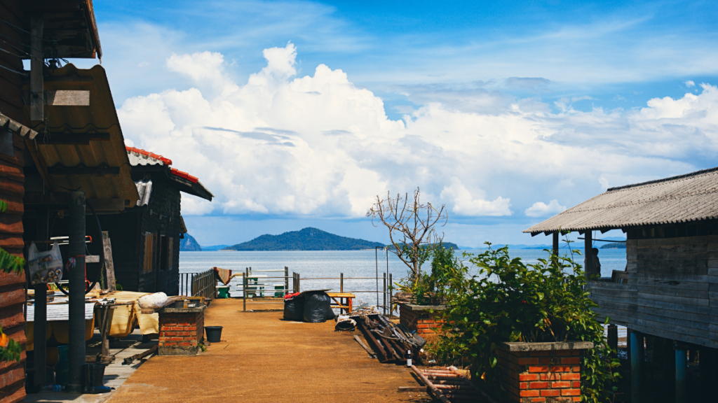 A boardwalk and teak shops with a view of the sea and islands in Lanta Old Town