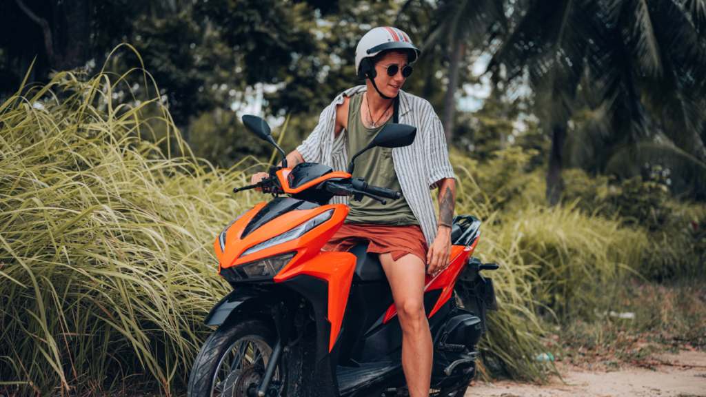 A tourist on a motorbike scooter explores the island