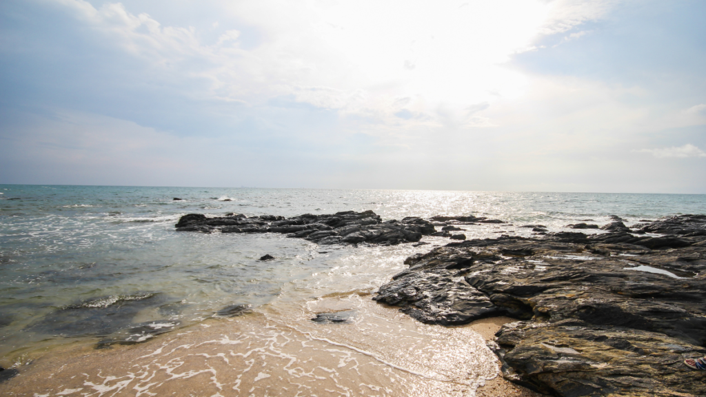 A rocky beach with the Andaman Sea extending to the horizon from Koh Lanta, Thailand